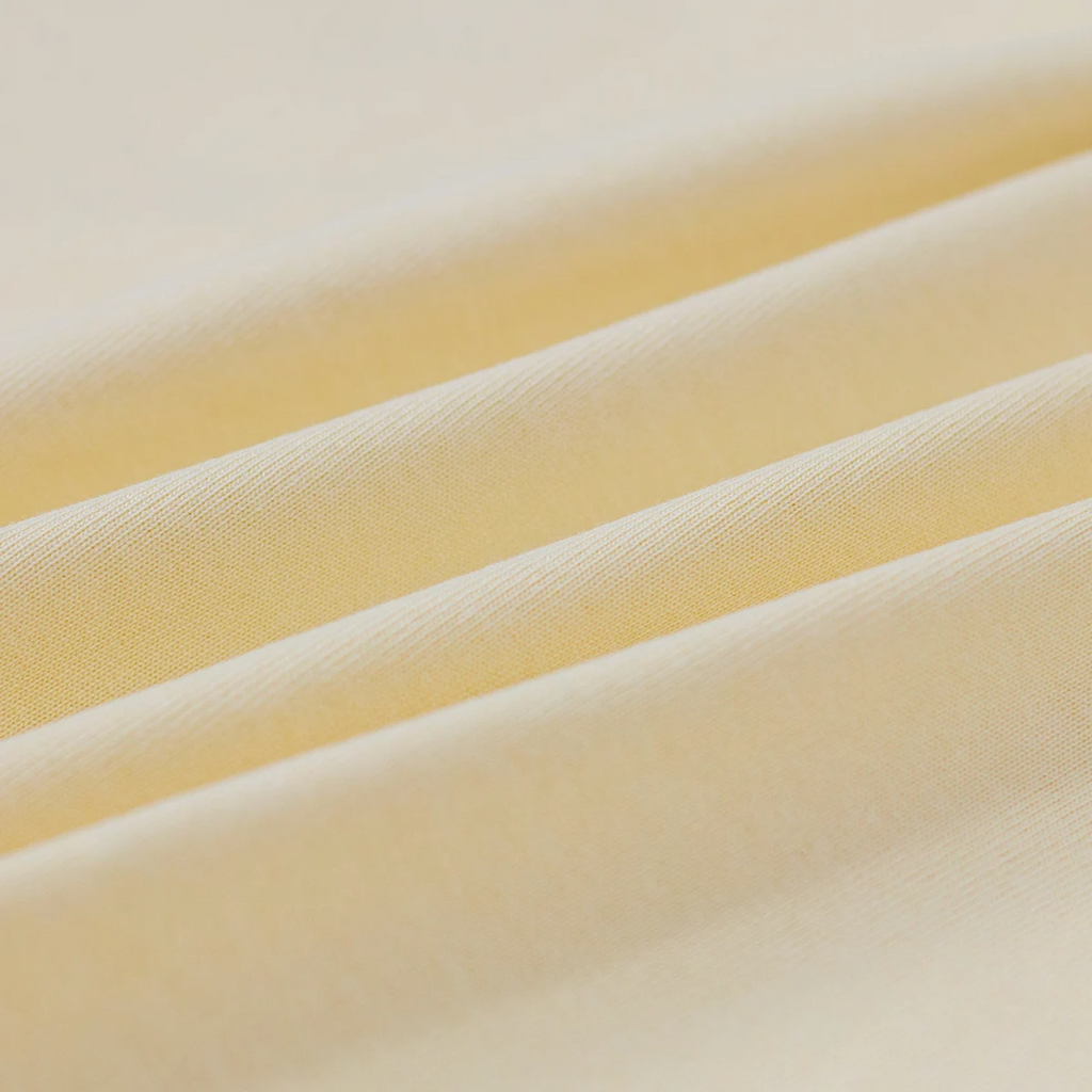 Close-up of yellow fabric with a soft texture