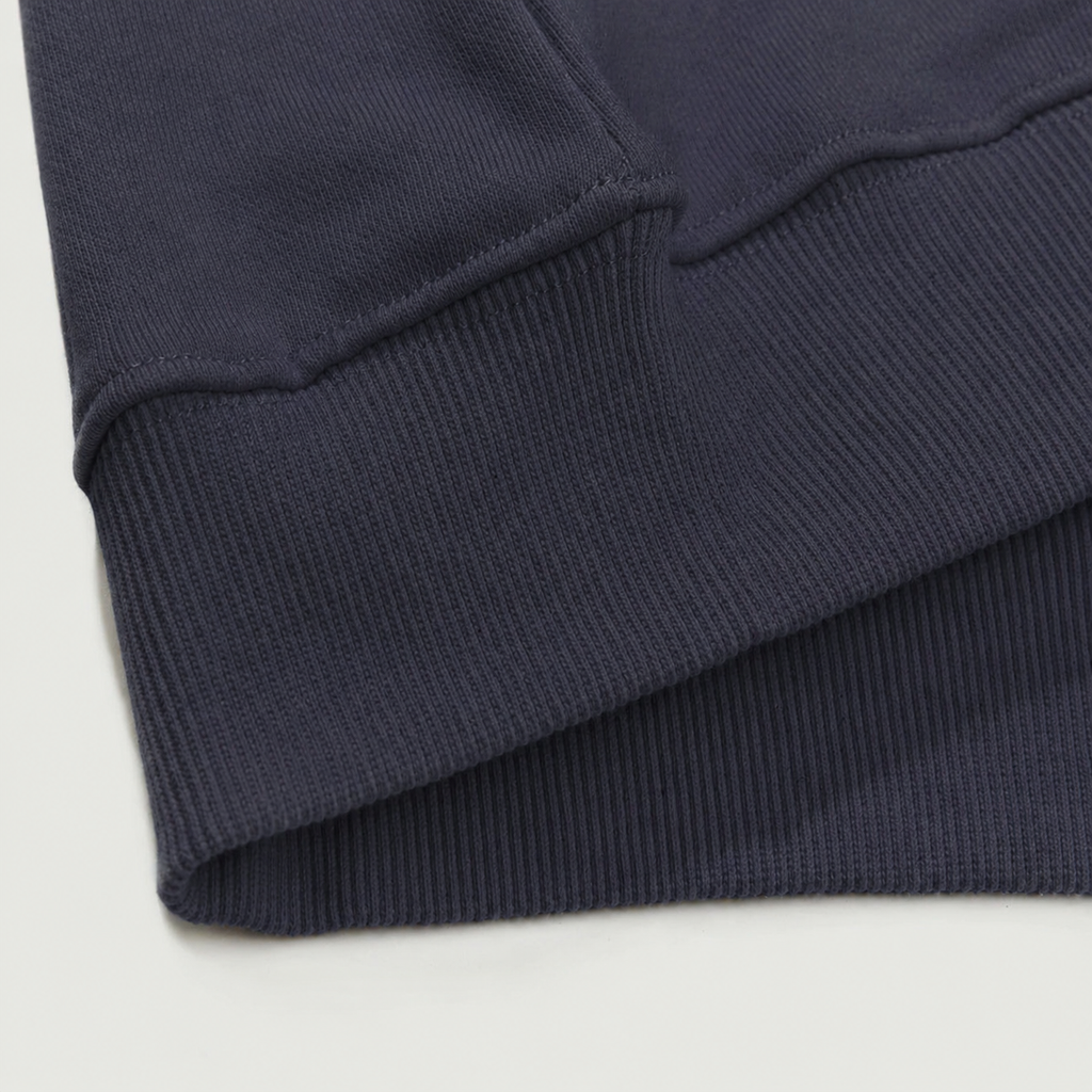 Close-up of a navy blue fabric with a textured pattern on a light gray background